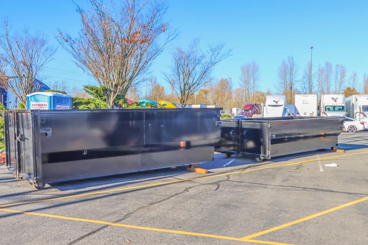 Professional dumpster rental service with roll-off container on residential driveway in Glenvar Heights